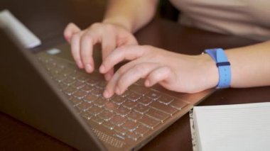 Kadın eller dizüstü bilgisayarın klavyesinde yazı yazıyorlar. Parmaklar klavyedeki tuşlara hızlıca basın. Onun yanında bir defter var. Kişisel bilgisayar, evde uzaktan çalışma, iş, çalışma, mesajlaşma, sohbet