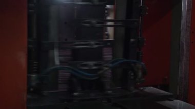 Newspapers fall into large pile and move along the conveyor line. Printing house. Paper editions move in a large stack along the cylinder line. Media, article, headline, daily news, print edition