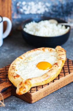 Khachapuri - traditional Georgian cheese and egg filled bread. Close up.