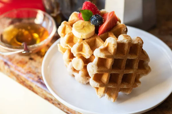 Belgian waffles, berries with honey and coffee. Breakfast concept.