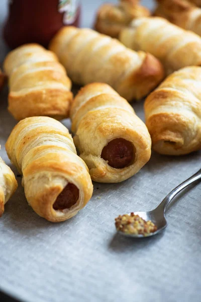 Pigs in a blanket - mini rolls with sausages wrapped in a puff pastry dough.