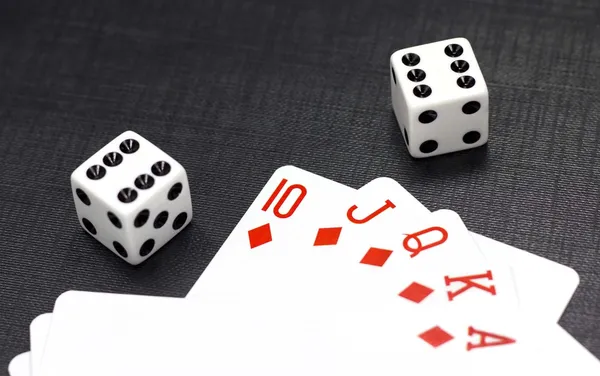 Dices and playing cards on a black background — Stock Photo, Image