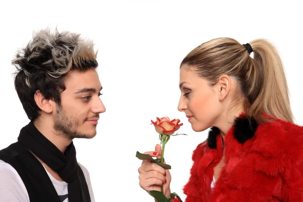 Beautiful young couple with a rose — Stock Photo, Image