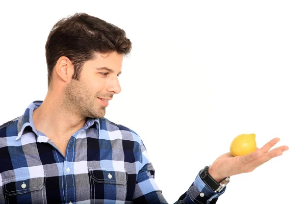 Young man holding a lemon — Stock Photo, Image