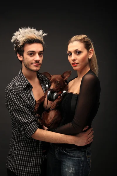 Stylish young couple with dog — Stock Photo, Image