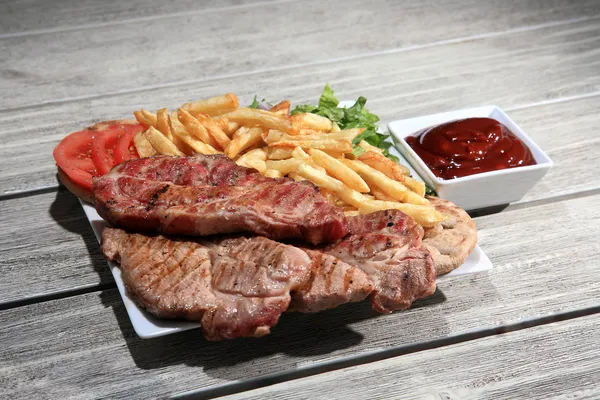 Pork steak on a plate — Stock Photo, Image