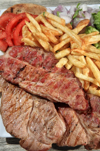 Pork steak on a plate — Stock Photo, Image