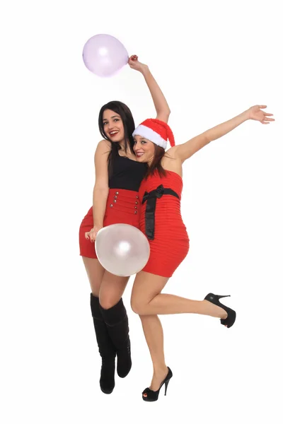 Hermosas chicas jóvenes con traje de Navidad divirtiéndose con globos —  Fotos de Stock