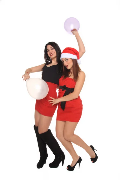 Hermosas chicas jóvenes con traje de Navidad divirtiéndose con globos —  Fotos de Stock