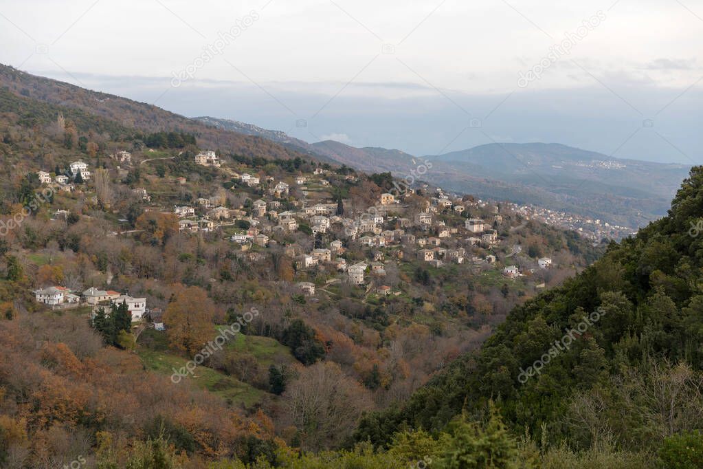 Panoramic view of a traditional village with stone houses on a cloudy day in Pelion, Greece