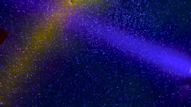 Multi-colored beams of light blink on a dark background.