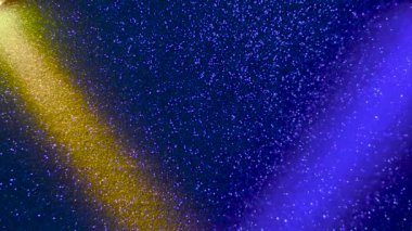 Multi-colored beams of light blink on a dark background.