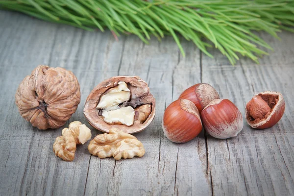 Nuts on the board on a textured background Christmas tree. — Stock Photo, Image