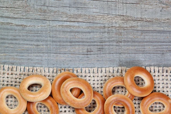 Christmas bagels on sackcloth texture wood. — Stock Photo, Image