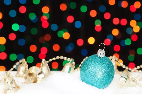 Blue Christmas ball and bells in the snow. On the background bok — Stock Photo, Image