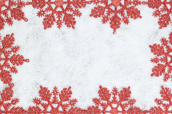 Christmas decorative frame with snowflakes closeup on snow. — Stock Photo, Image