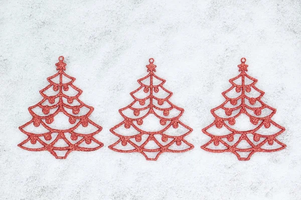 Three decorative Christmas tree closeup on the snow. — Stock Photo, Image