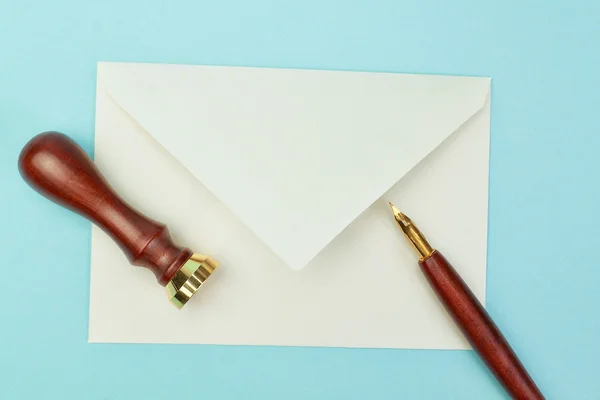 Stationery and office supplies postal envelope on a blue backgro — Stock Photo, Image