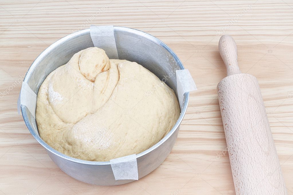 Easter dough in the pan and a rocking chair on a wooden table.