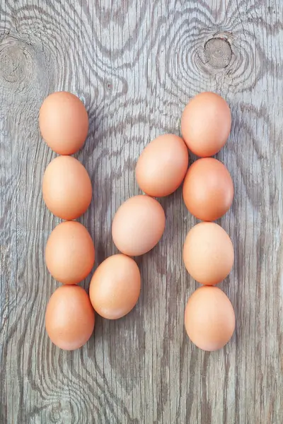 A letter n from the eggs for Easter. On a wooden texture. – stockfoto