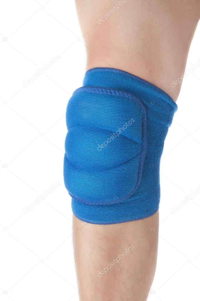 Knee protection in games on the male leg. Close-up. On a white b