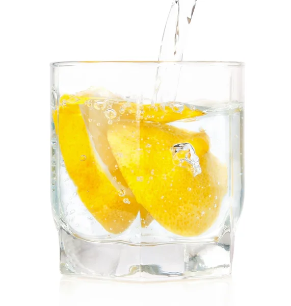 A glass of cold drink with a lemon from the fridge. On a white b — Stock Photo, Image