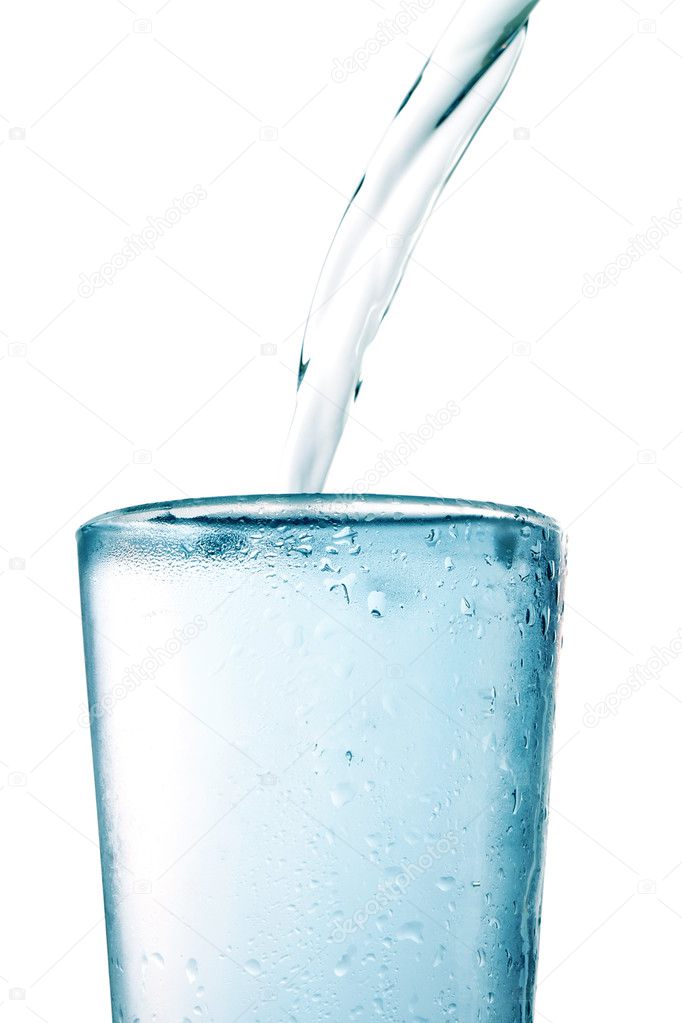 Cold water is poured into a glass. On a white background.