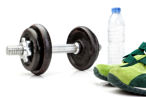 Dumbbell, a bottle of pure water in the background and running s — Stock Photo, Image