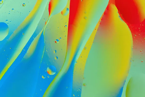 Dekorative Formen von Öl auf einen farbigen Hintergrund. Abstraktion. — Stockfoto