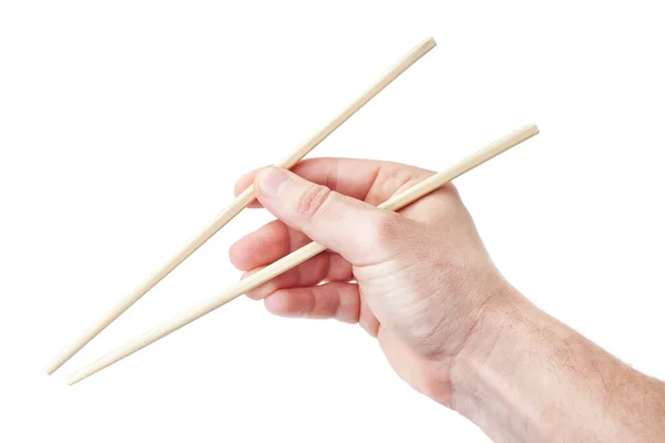 Chinois bâtons baguettes, dans la main de l'homme pour les sushis. sur un blanc — Photo