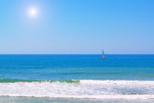 Яхта в синьому морі влітку. Під яскравим сонцем . — стокове фото