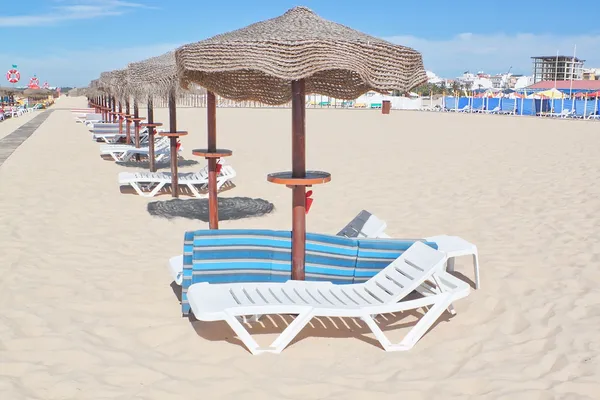 Sombrillas de madera en una fila en una playa soleada. para el resto. —  Fotos de Stock