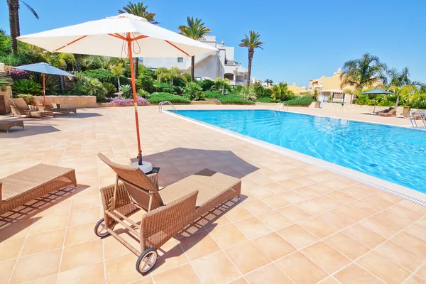 Mooi zwembad voor vakanties en paraplu zon beds.portugal algarve — Stockfoto