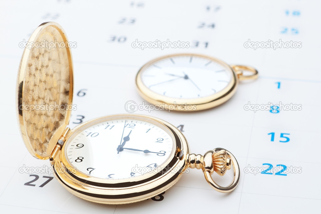 Two pocket watch against the background of the calendar. Close-u