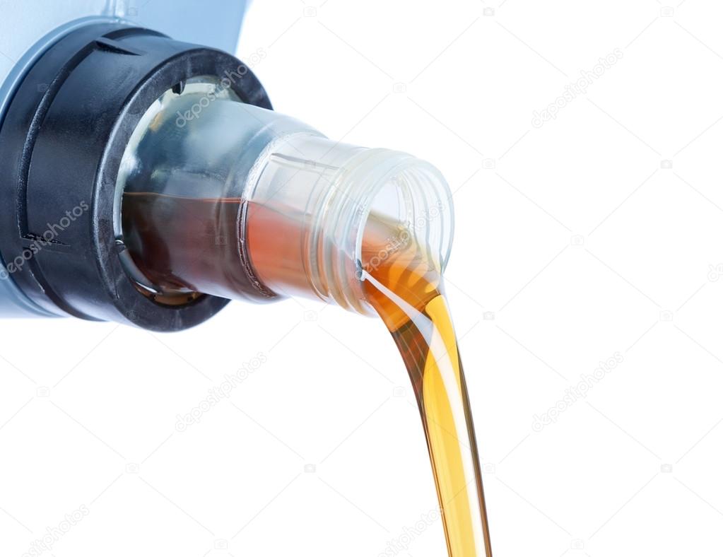 Engine oil pouring from a plastic canister. On a white backgroun