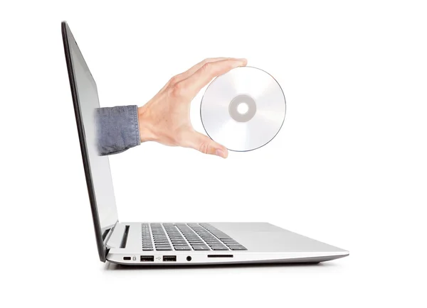 Man's hand holding a disk sticking out of the notebook. Concept — Stock Photo, Image