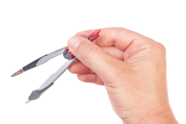 Man's hand holding a geometric compass. On a white background. Stock Image