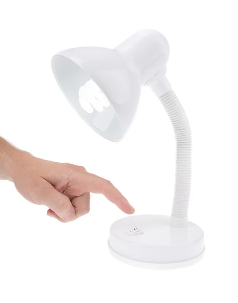 Mannes Hand Sie die Schreibtischlampe im Büro. auf weißem Hintergrund. — Stockfoto