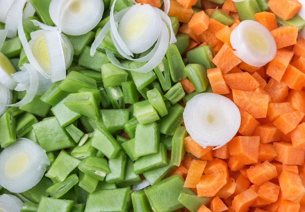 Groenten erwten en wortelen segmentering voor salade en soep. Close-up. — Stockfoto