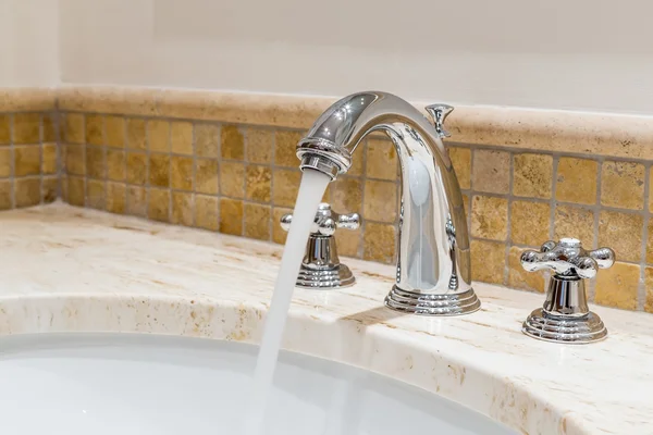 Modern water tap in the bathroom. Flowing water. — Stock Photo, Image