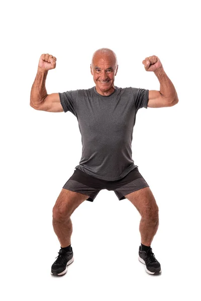 Elderly retired man, athlete, raised his hands up, celebrating victory and success. On white background. — Stock Photo, Image