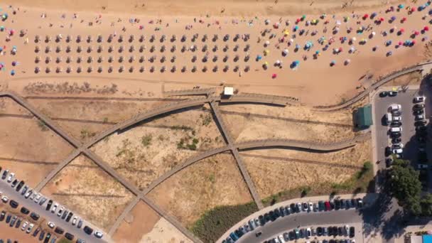 Antenne. Drohnenflug über den Stränden und Holzwegen der portugiesischen Stadt Quarteira, mit Touristen auf Sonnenliegen. Portugal Algarve. Ansicht von oben — Stockvideo