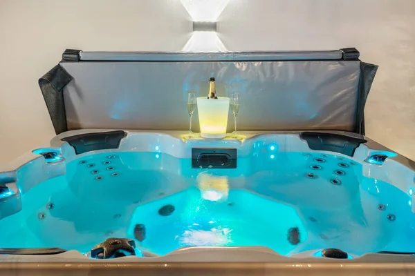 Relax romantic dinner with champagne in a luxury Jacuzzi bath for therapeutic massage and relaxation, close-up.