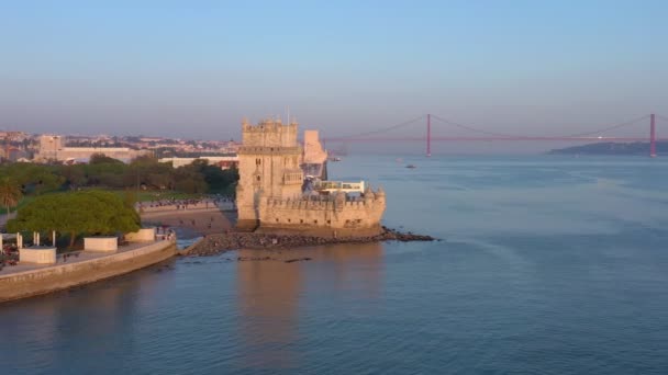 Lisszabon, Portugália, Belem torony, Torre de Belem. A Tagus folyónál naplementekor, 25-ös híd, Abril — Stock videók