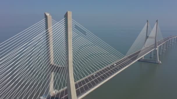 Lisbon, Portugal, aerial view of the Vasco da Gama bridge, on a foggy beautiful morning, during car traffic. — Stock Video