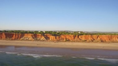 Falesia 'nın güzel Portekiz güney sahillerinin hava videosu. Sandy dağları turistler tatilde..