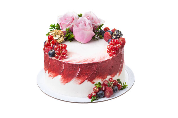 Delicate summer fruit cake made from fruits, berries and rose flowers on a white isolated background.