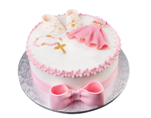 Eine kreative rosa Torte mit einem Kreuzkleid und Stiefeln zur Taufe eines neugeborenen Mädchens. Nahaufnahme von oben. — Stockfoto