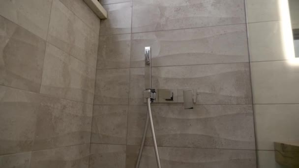 Bottom up view of shower room with modern ceramic tile furnishings close-up. — Stock Video