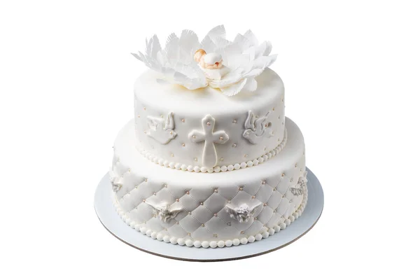砂糖で作られたお祭りの白いケーキ 人形の装飾を持つ赤ちゃんの洗礼のために 十字架と口紅の花 ストック画像
